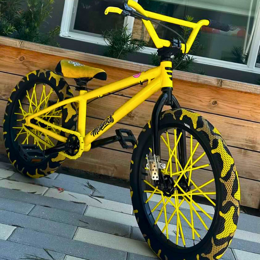 Customizable BMX Bikes featuring a vibrant yellow design and unique tire patterns, showcasing style and individuality.