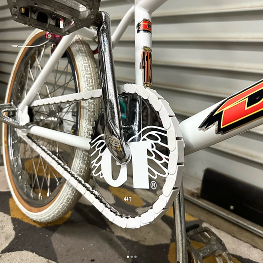 Close up of white insane chain caps on a white custom GT Dyno bike