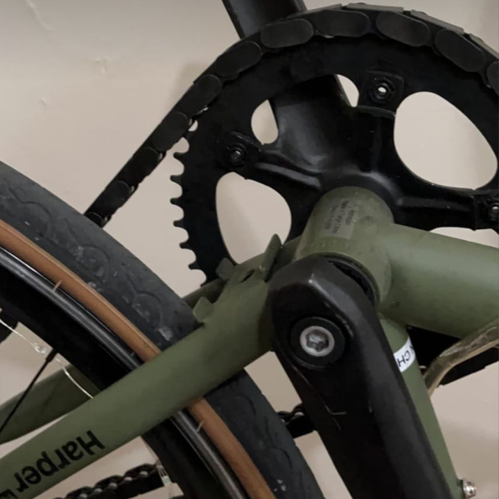 BMX Bikes 16 inch and larger featuring black snap-on chain caps on a green bike.