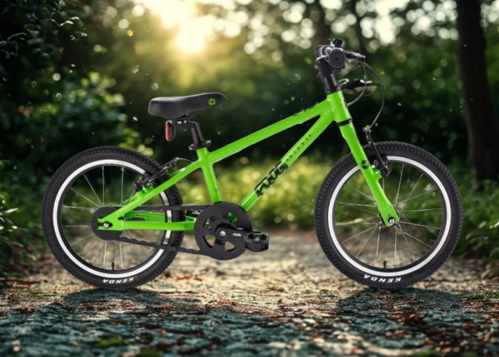 Green children's Frog bicycle with Insane Chains Black Snap on Caps on a gravel path with a blurred natural background