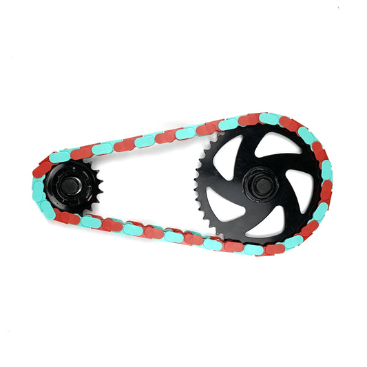 Colored Bike Chain in teal and red two tone design, enhancing bike style and performance.