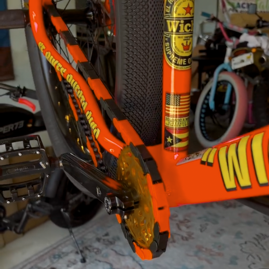 Bike Chain Cover in black and orange colors, showcasing bright design on a bicycle.