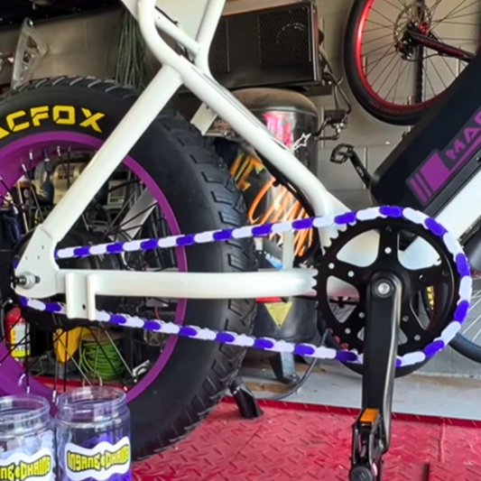 Macfox purple and white two tone insane chains on bike showing custom style and bold colors.