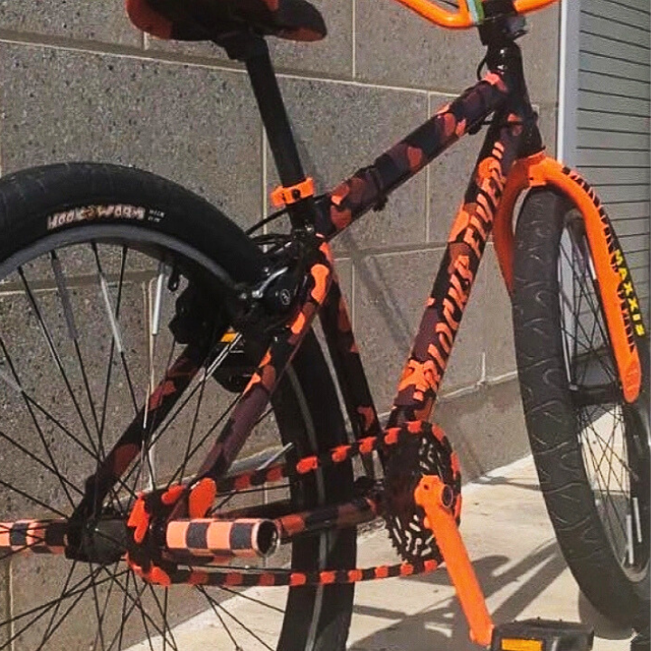 Bike Chain Cover in black and orange on a stylish bicycle, showcasing its unique two-tone design.