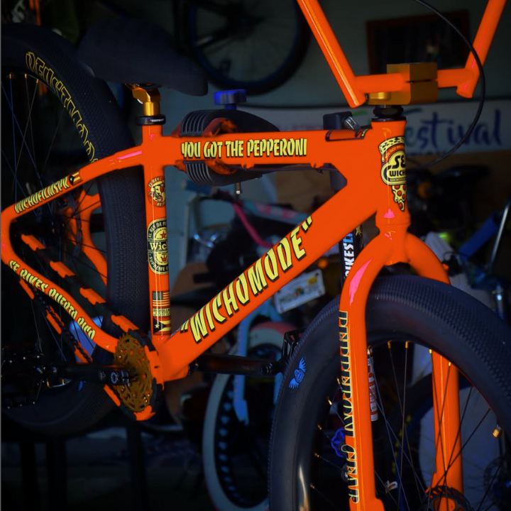 Bike Chain Cover in vibrant orange with black accents on a stylish bike.