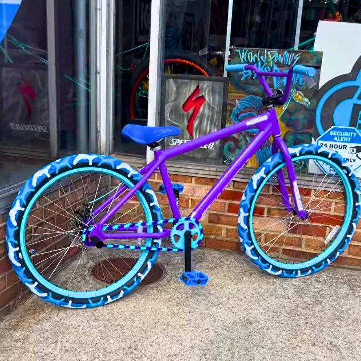 Childs 14 Inch Bike in purple and teal with eye-catching designs, perfect for fun rides and showing off at the park.