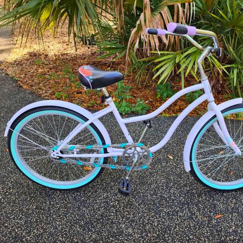 Insane Chains chrome and teal snap-on bike chain caps on white beach cruiser, custom bike chain cover.