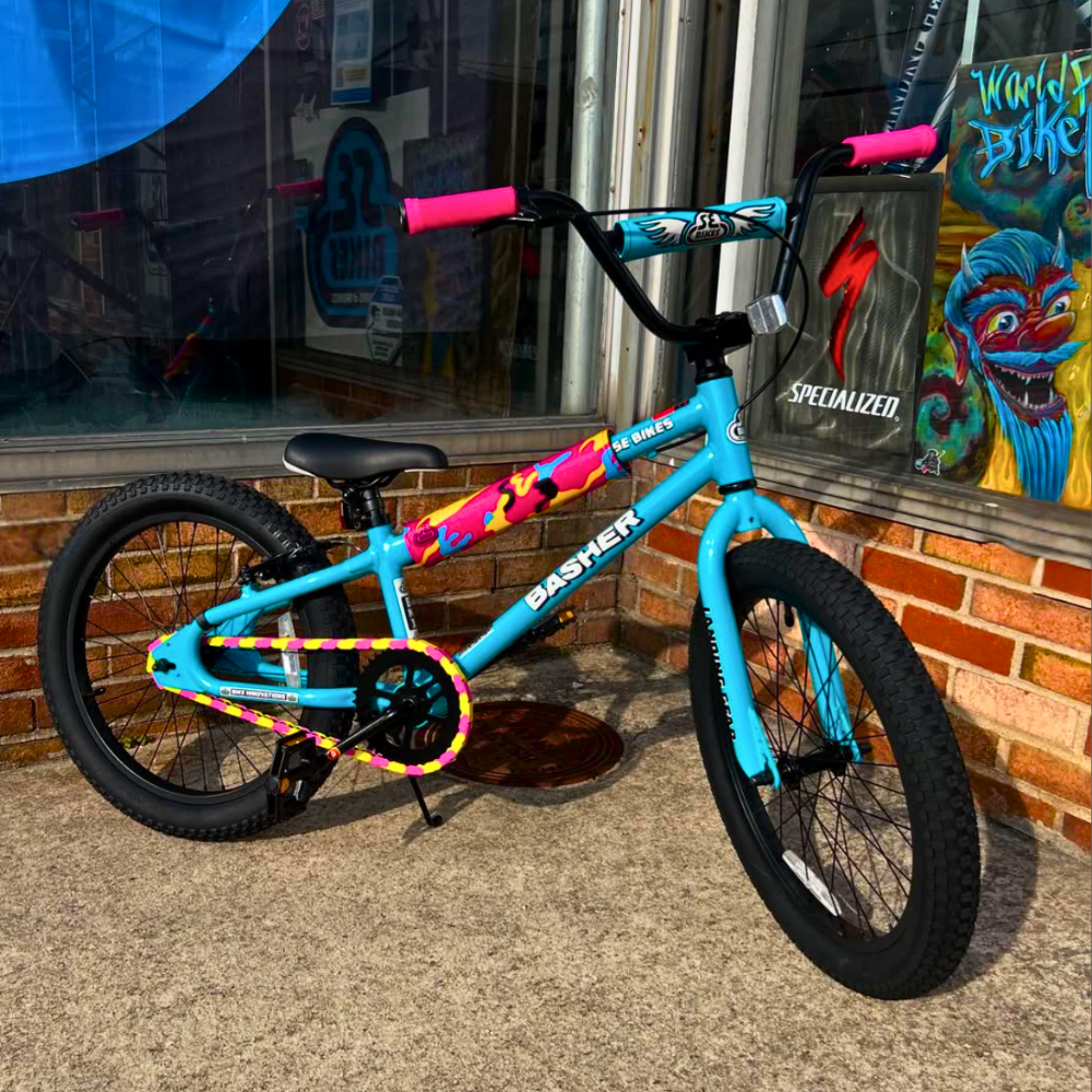 Insane Chains pink and yellow snap-on bike chain caps on kids SE Basher BMX, fun custom bike accessory.