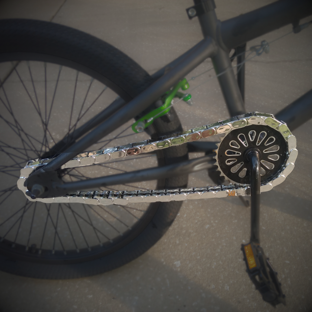 Bike Chain Cover featuring shiny chrome snap-on caps for a stylish bike chain detail.