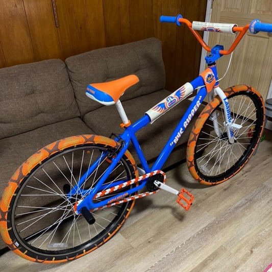 SE Bike Chain in action with vibrant white and orange two-tone colors on a stylish bike.
