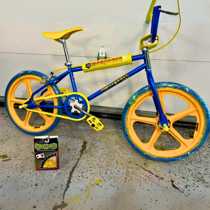 Customizable BMX Bikes featuring vibrant yellow snap-on chain caps and blue frame with orange wheels.