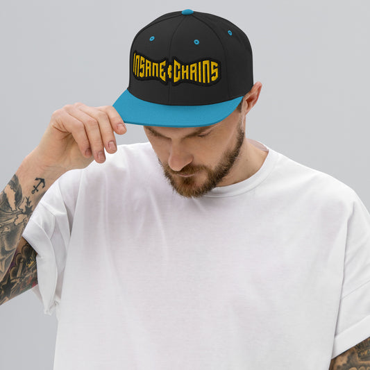 Insane Chains Snapback Hat worn by man with tattoos, featuring a structured design and bold logo.