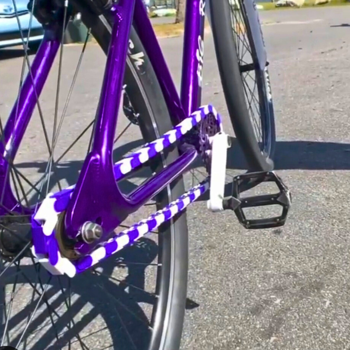 bmx bike featuring purple and white Insane Chains with snap-on caps for a stylish look.