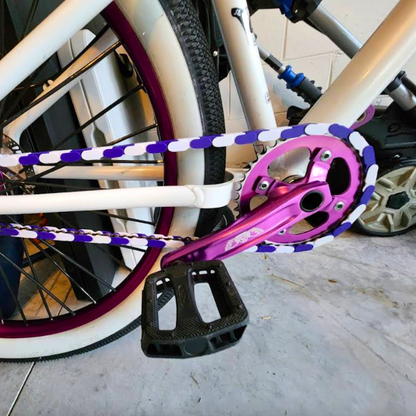bmx purple and white two tone insane chains on a bike with stylish pedal and crankset.