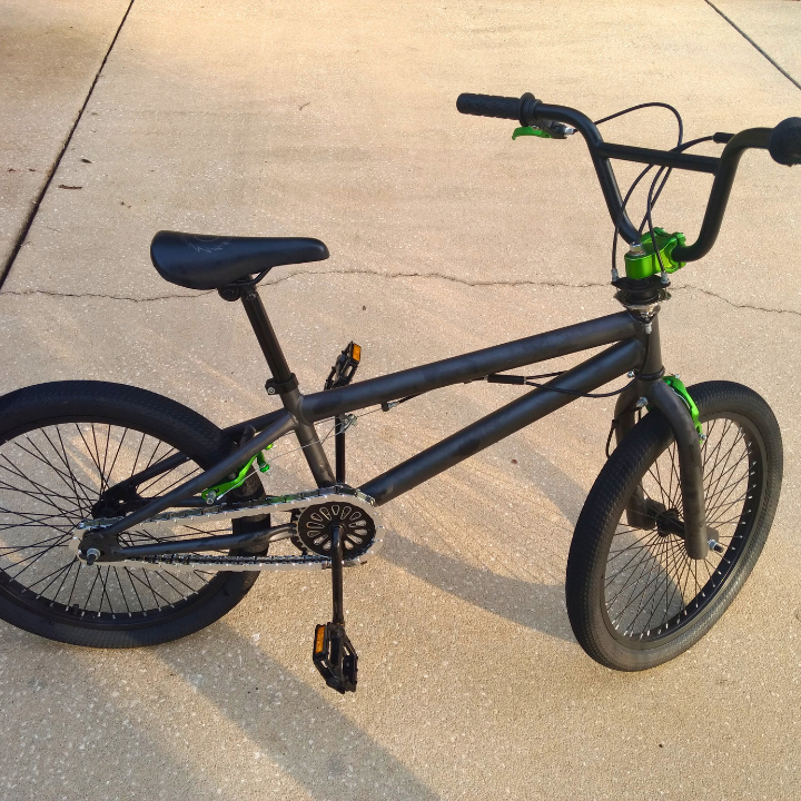 Black bicycle on a concrete surface with chrome insane chains