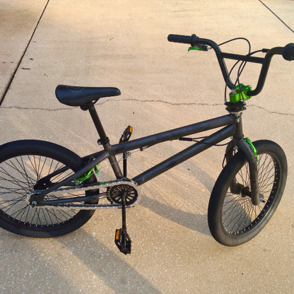 Black bicycle on a concrete surface with chrome insane chains