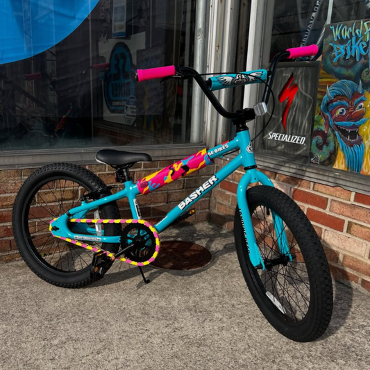 Bike Chain Accessories showcased on a vibrant bike with pink and yellow two-tone chain caps for style and function.